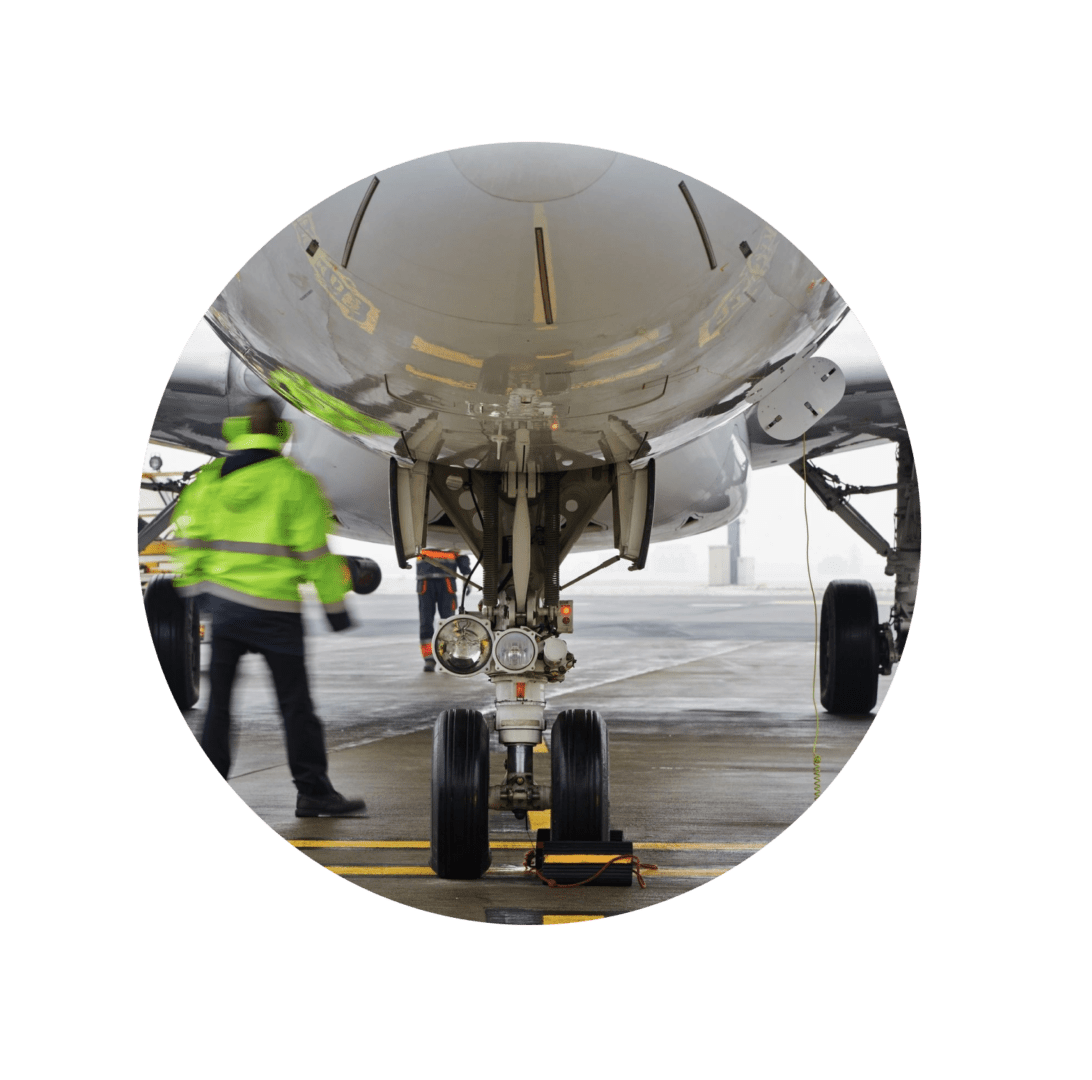 A man standing next to an airplane on the ground.